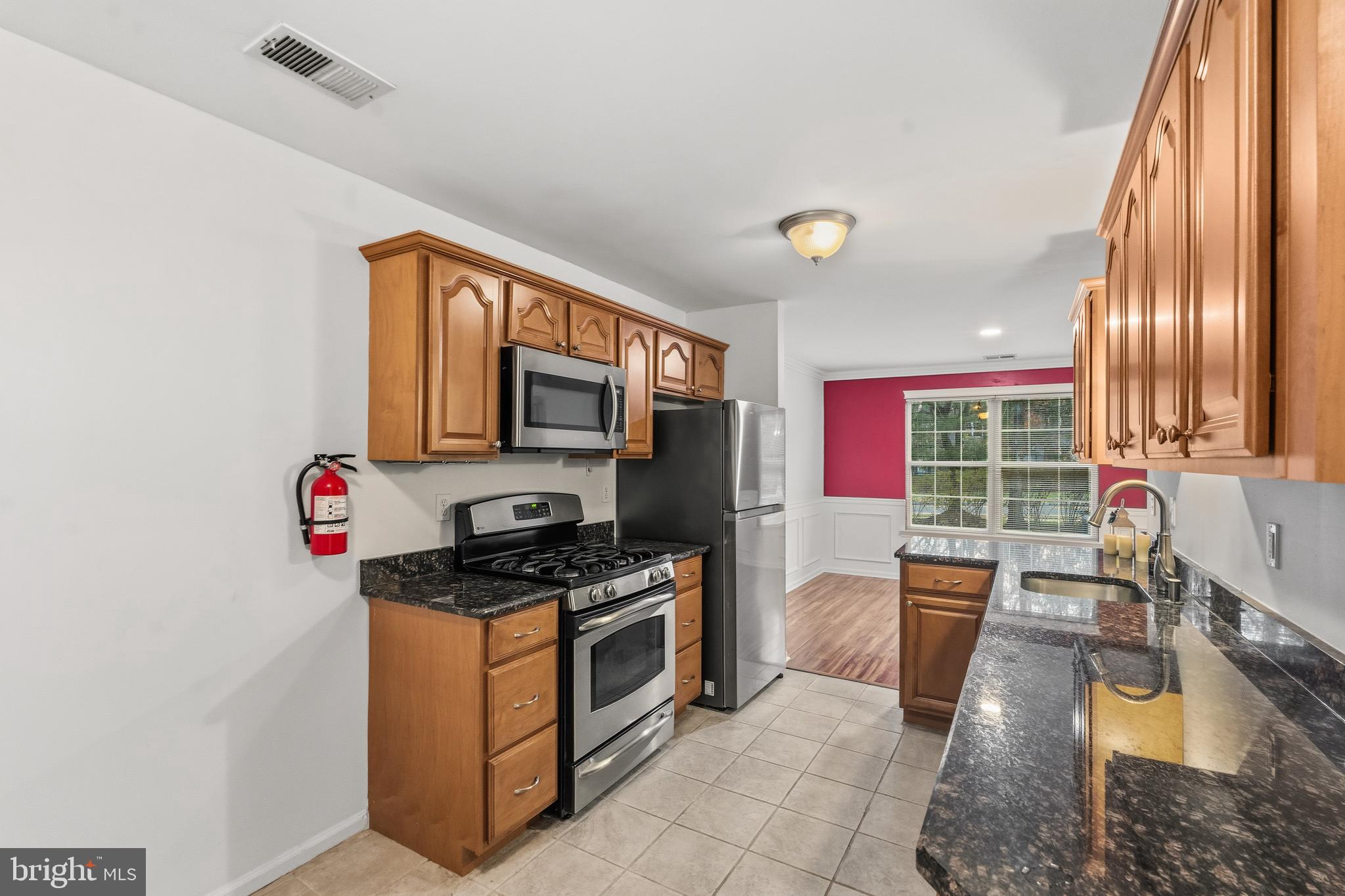 8 Brookline Court, Unit B Princeton, NJ 08540 - Photo 23 of 53 a kitchen with stainless steel appliances granite countertop a stove a sink and a microwave