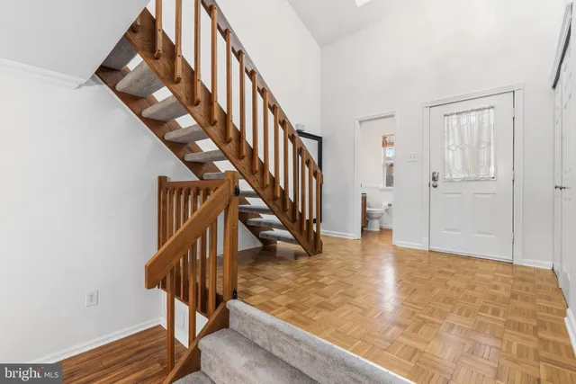 a view of entryway and hall with wooden floor