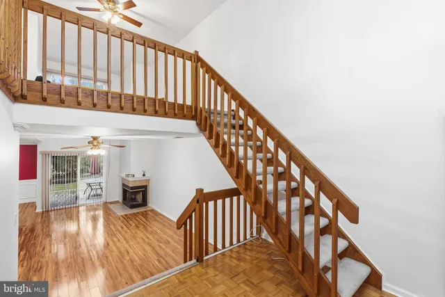 a view of a hallway with wooden floor and stairs