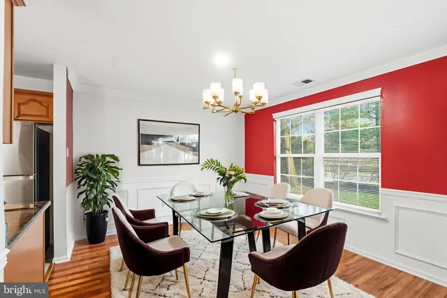 a dining room with furniture and a chandelier