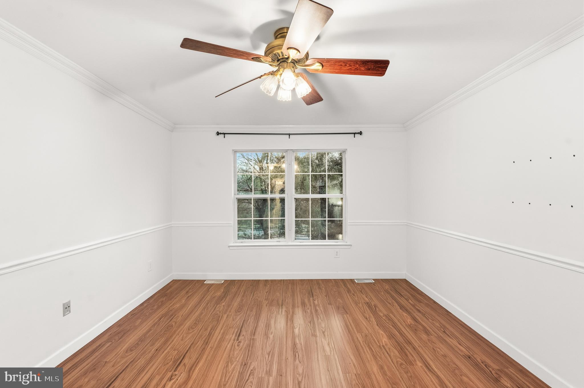 8 Brookline Court, Unit B Princeton, NJ 08540 - Photo 38 of 53 an empty room with wooden floor chandelier fan and windows