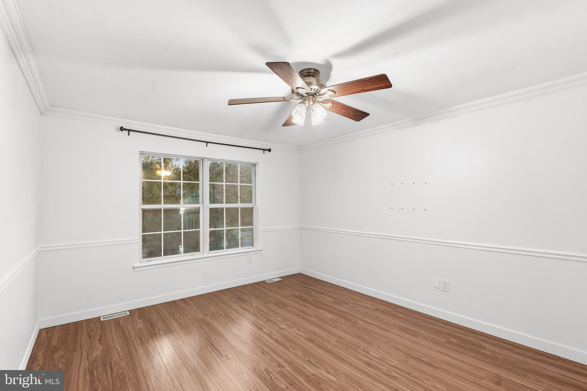 8 Brookline Court, Unit B Princeton, NJ 08540 - Photo 39 of 53 an empty room with a window and a ceiling fan