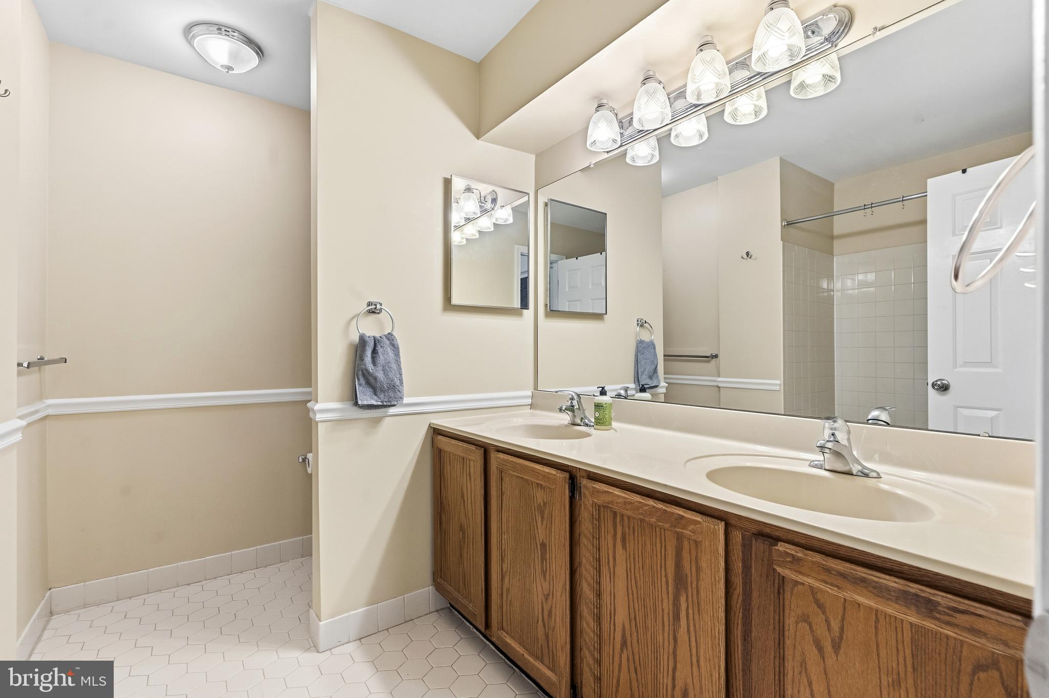 8 Brookline Court, Unit B Princeton, NJ 08540 - Photo 41 of 53 a bathroom with a sink vanity granite and a mirror