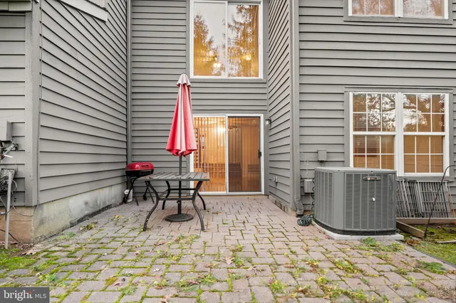 a view of backyard with seating space and wooden fence