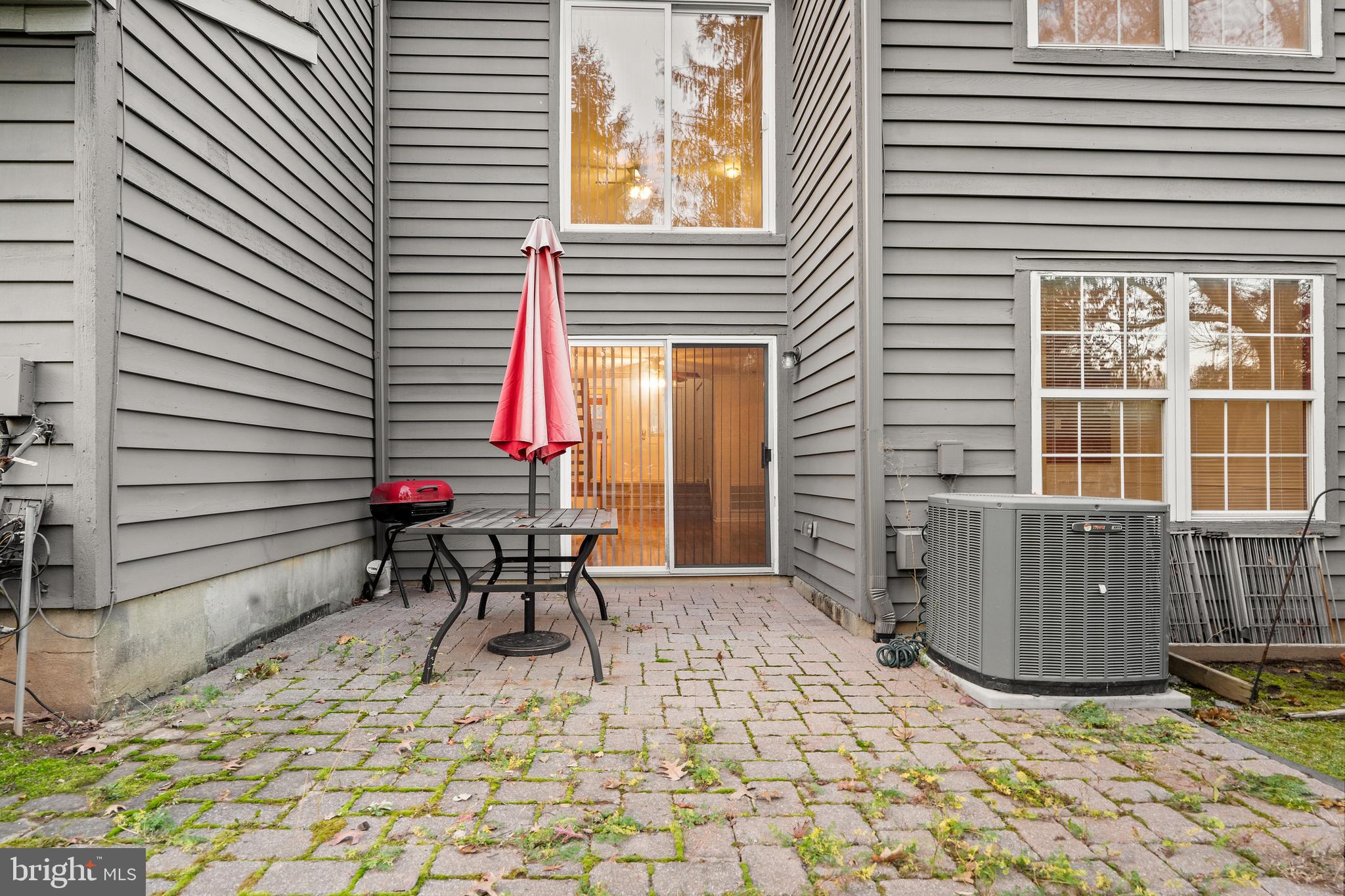 8 Brookline Court, Unit B Princeton, NJ 08540 - Photo 49 of 53 a backyard of a house with table and chairs