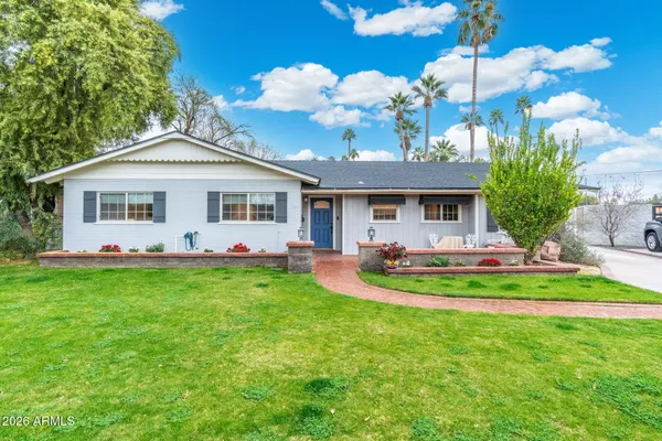 a front view of a house with swimming pool having outdoor seating