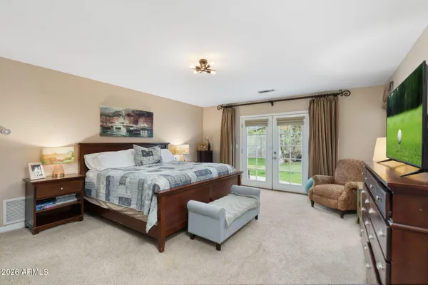 a bedroom with a bed and a mirror