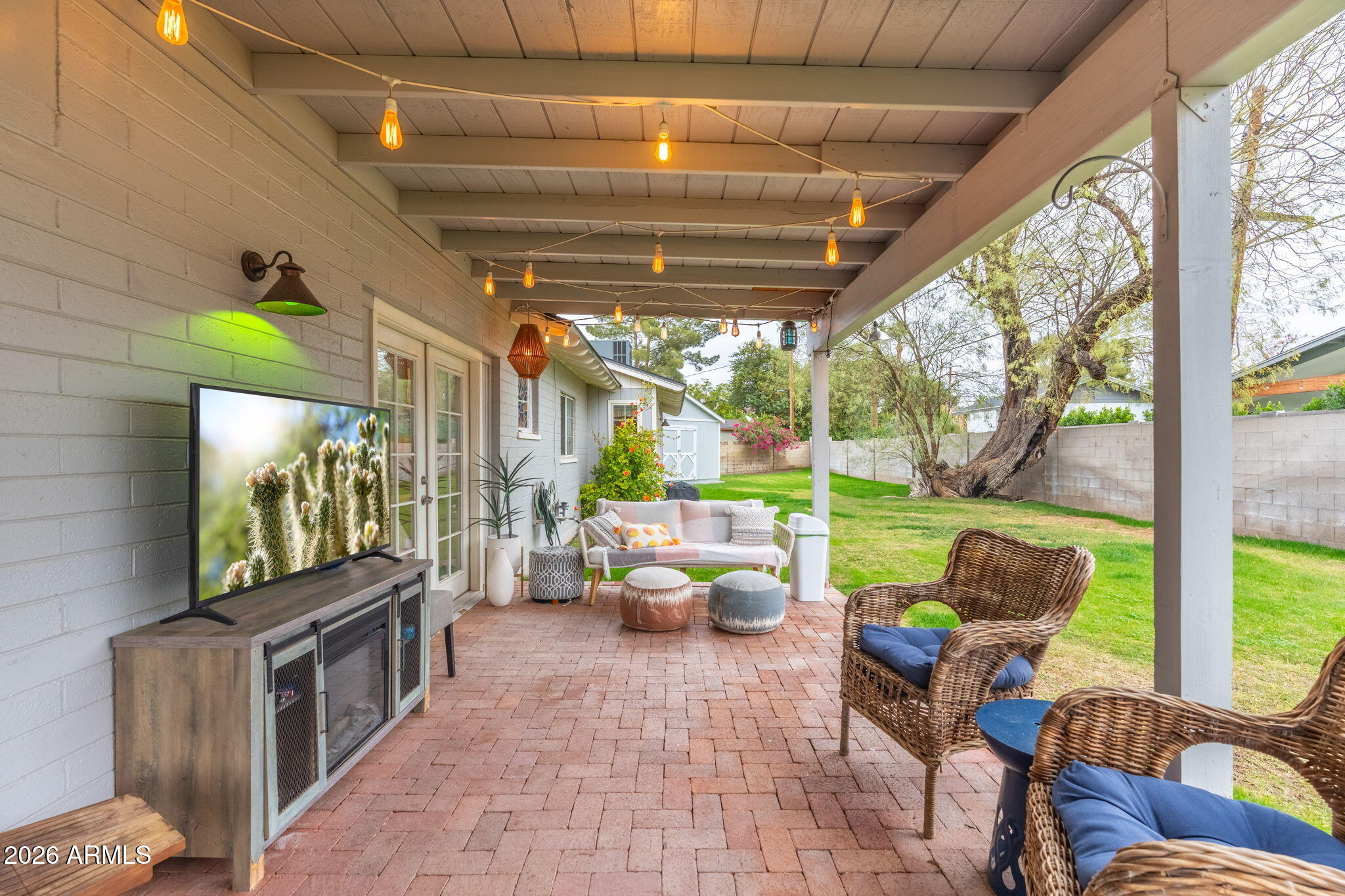 3033 North 53rd Street Phoenix, AZ 85018 - Photo 33 of 40 a living room with patio furniture and a flat screen tv