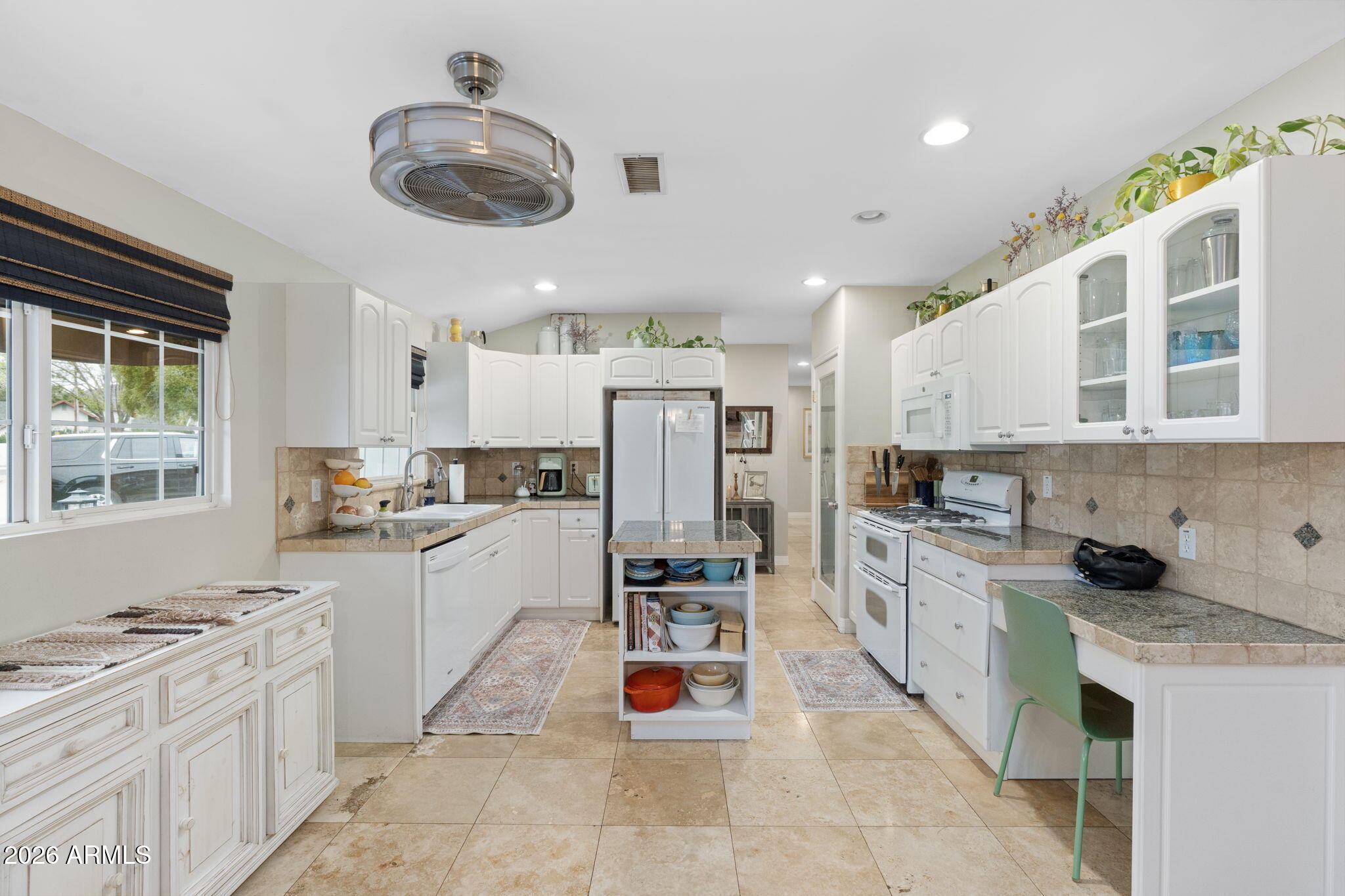 3033 North 53rd Street Phoenix, AZ 85018 - Photo 8 of 40 a kitchen with stainless steel appliances kitchen island granite countertop a sink and cabinets