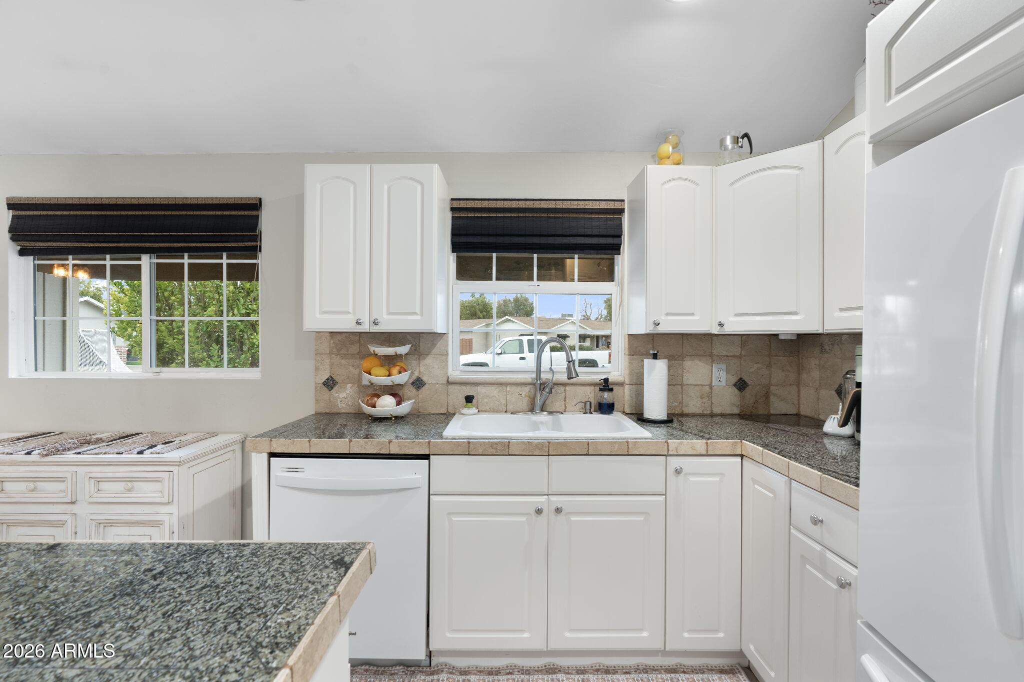 3033 North 53rd Street Phoenix, AZ 85018 - Photo 9 of 40 a kitchen with granite countertop a sink stove and cabinets