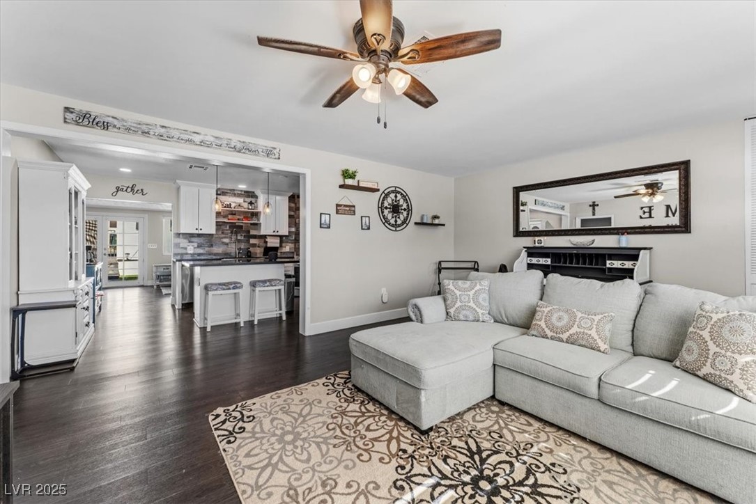 556 7th Street Boulder City, NV 89005 - Photo 2 of 37 Living room featuring ceiling fan and dark wood finished floors