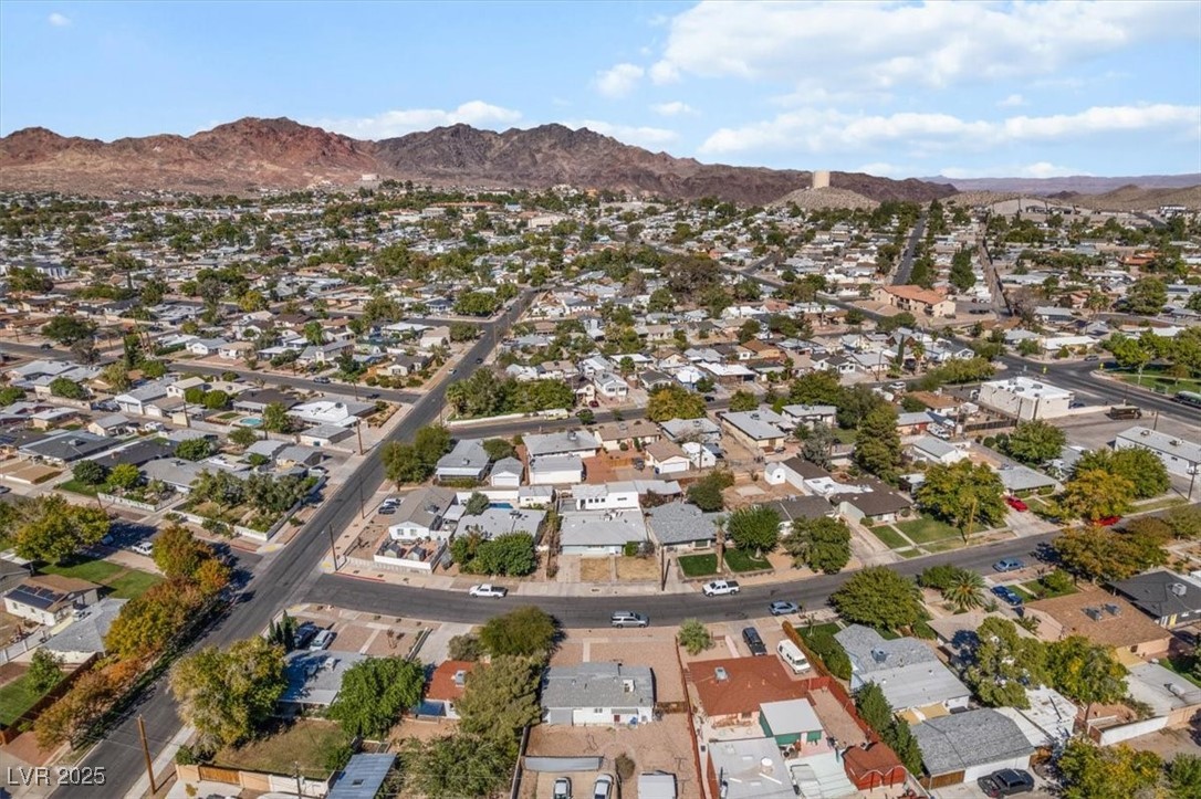 556 7th Street Boulder City, NV 89005 - Photo 34 of 37 Aerial overview of property's location with a mountain backdrop and nearby suburban area