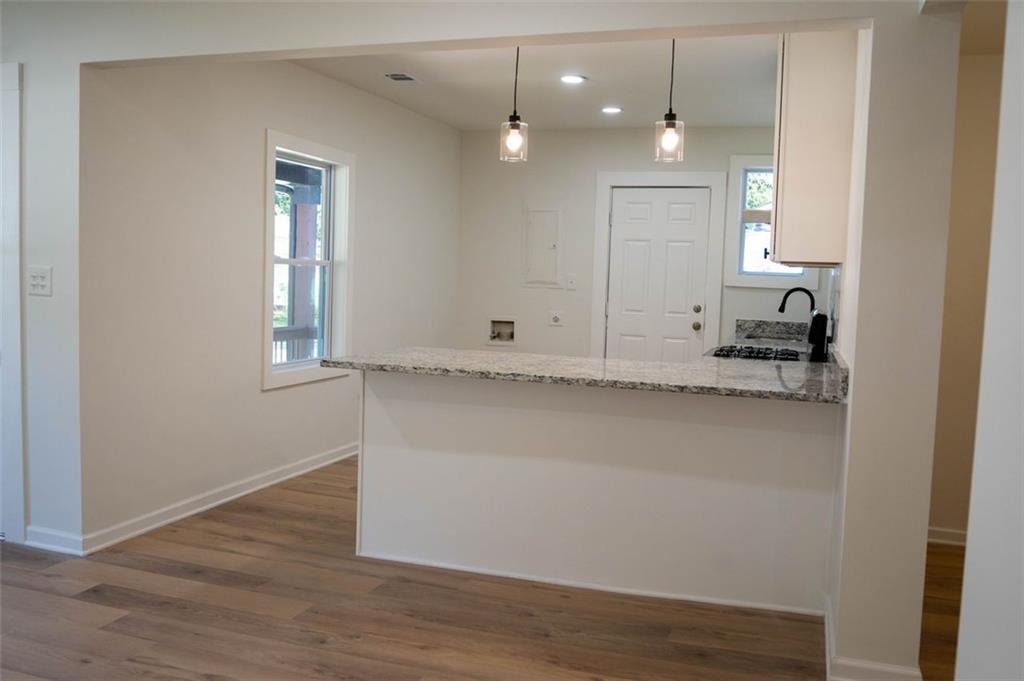 1404 Byrere Terrace Southwest Atlanta, GA 30310 - Photo 22 of 49 a view of an empty room with wooden floor and a window