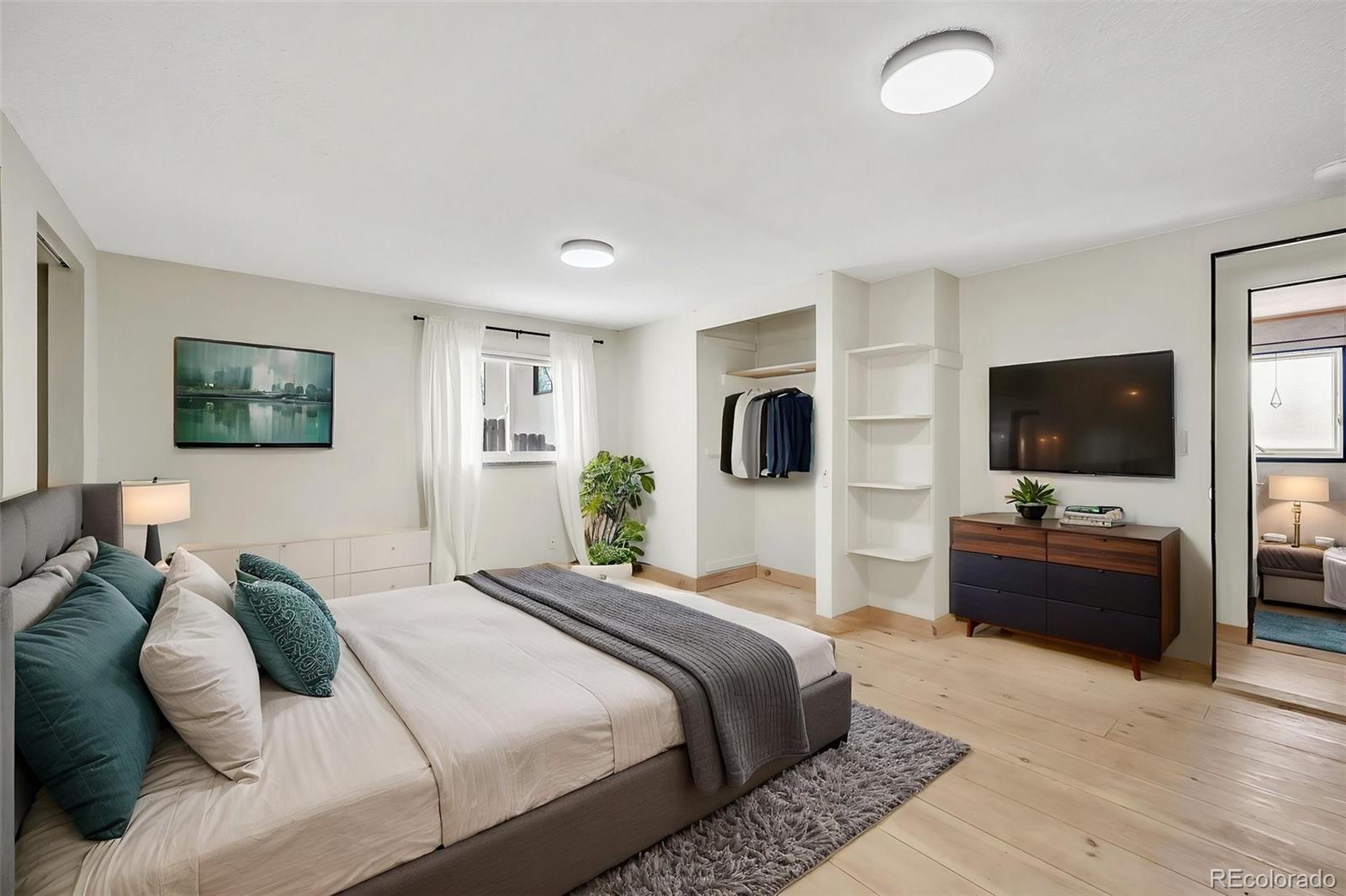 1624 Cheyenne Boulevard Colorado Springs, CO 80906 - Photo 19 of 47 a bedroom with a bed and a flat screen tv