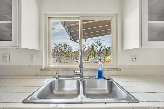 a kitchen with a sink stove and cabinets
