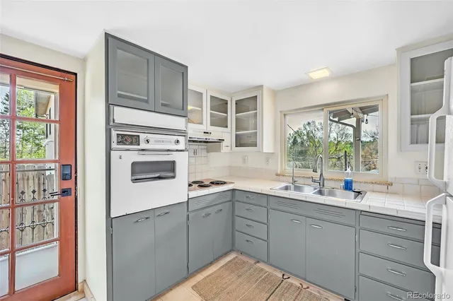 a kitchen with a sink a refrigerator and window