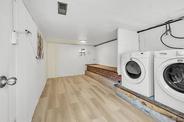 a view of a workspace with furniture and stairs