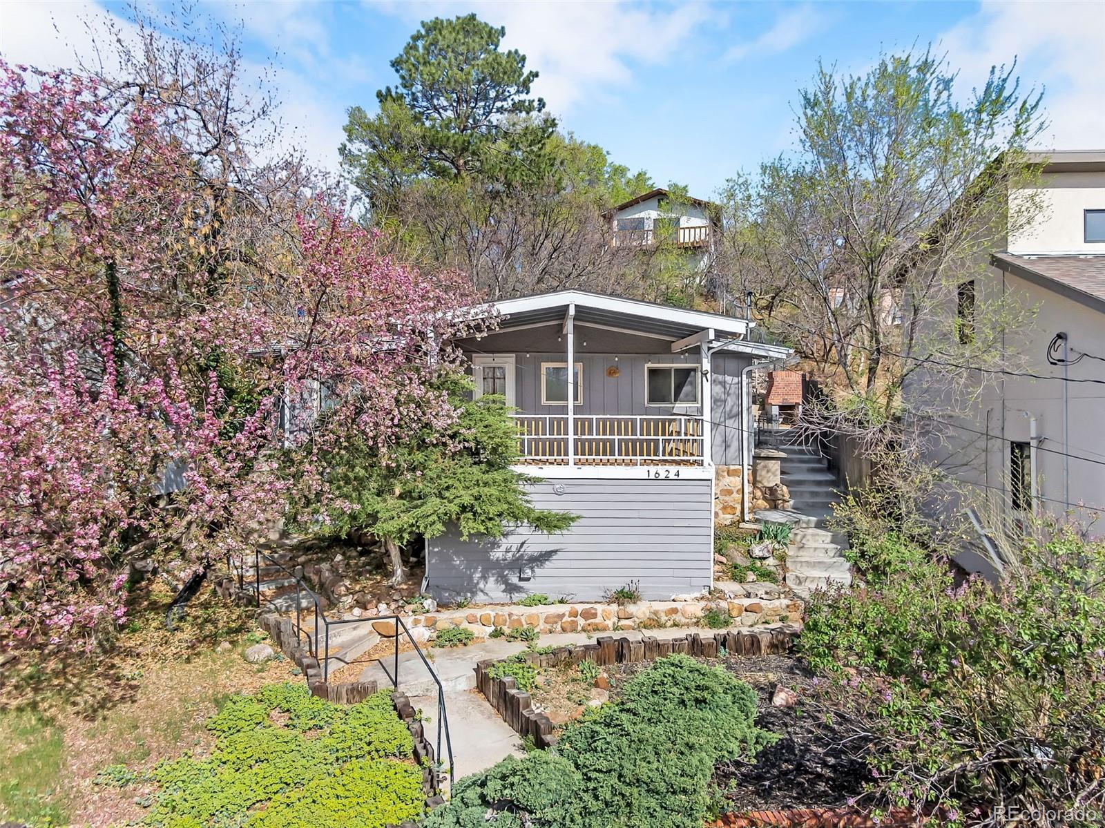 1624 Cheyenne Boulevard Colorado Springs, CO 80906 - Photo 3 of 47 a front view of a house with a yard