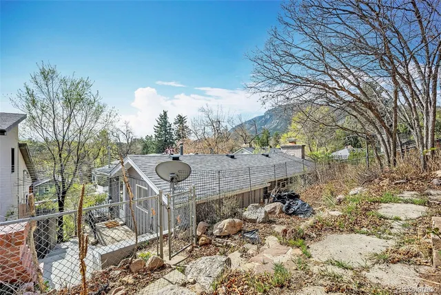 an aerial view of a house with a yard and potted plants
