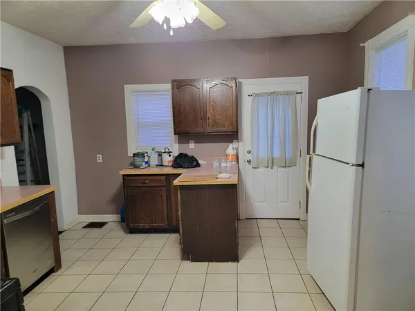 a kitchen with a refrigerator and a stove