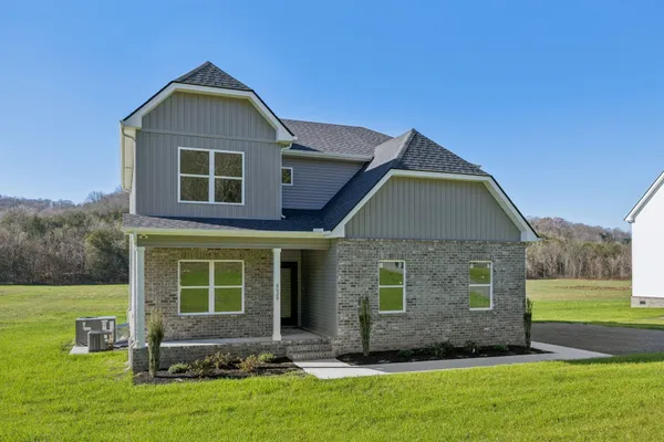 a front view of a house with a yard
