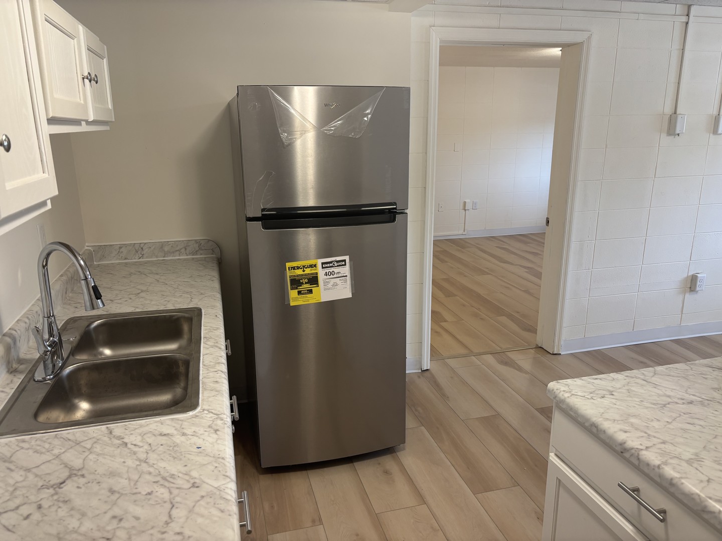 1231 North Galena Avenue, Unit 212 Dixon, IL 61021 - Photo 2 of 7 a kitchen with a refrigerator and a sink