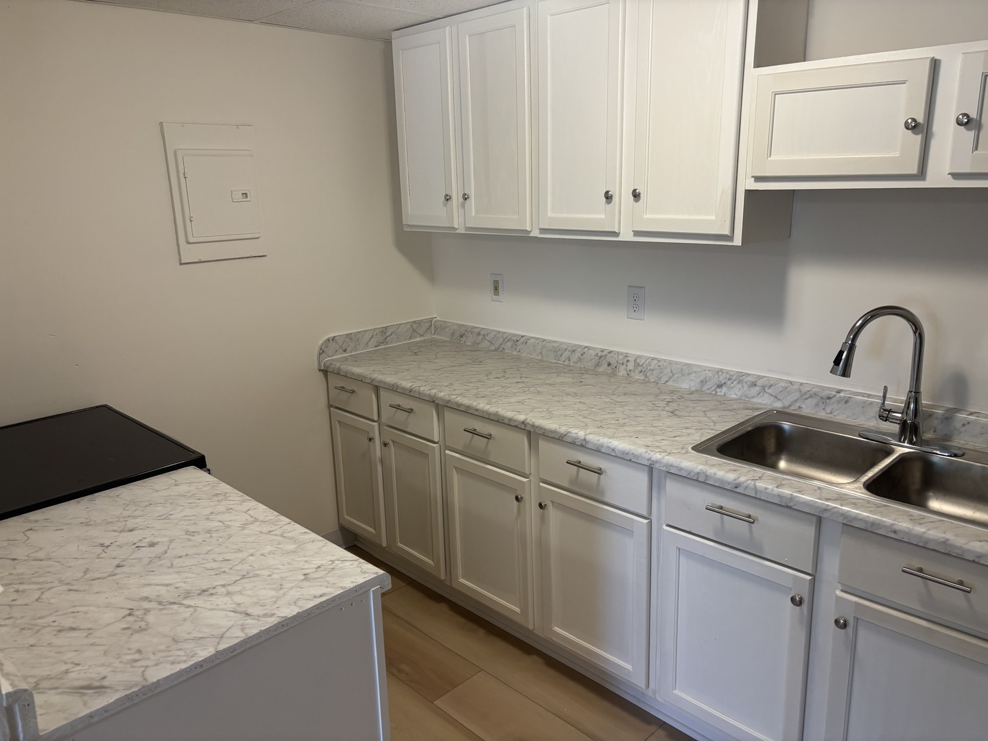 1231 North Galena Avenue, Unit 212 Dixon, IL 61021 - Photo 3 of 7 a kitchen with granite countertop white cabinets and sink