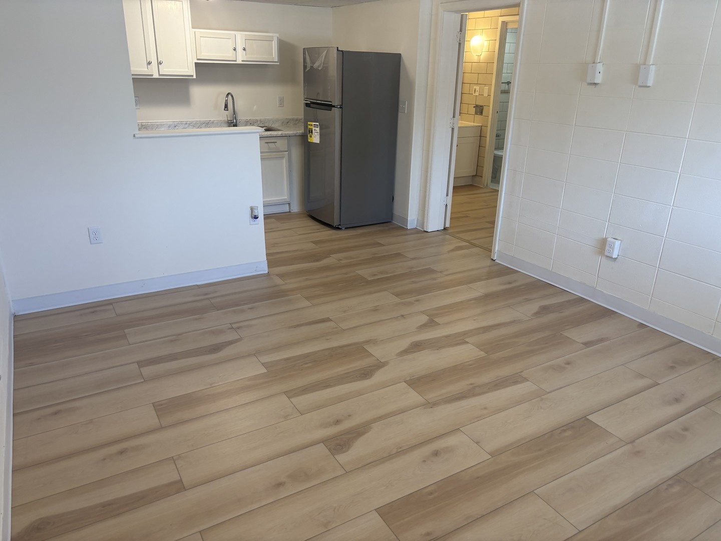 1231 North Galena Avenue, Unit 212 Dixon, IL 61021 - Photo 4 of 7 a view of a kitchen with wooden floor and a refrigerator