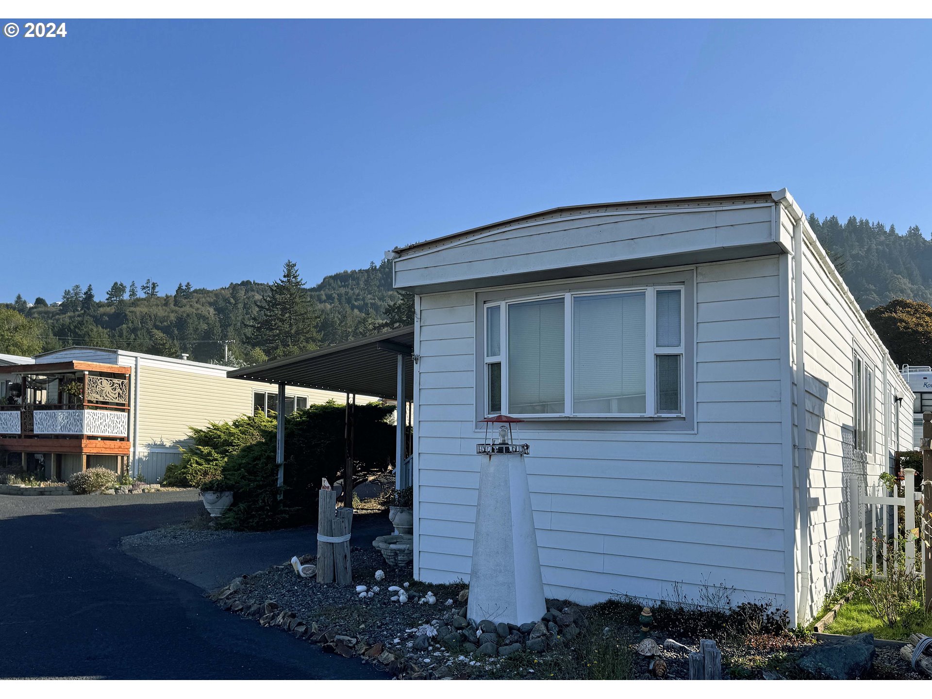 97972 Hallway Road, Unit 22 Brookings, OR 97415 - Photo 9 of 46 a view of a house with a yard