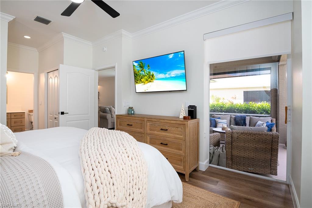 21441 Knighton Run Estero, FL 33928 - Photo 15 of 50 a bedroom with a bed and a flat screen tv