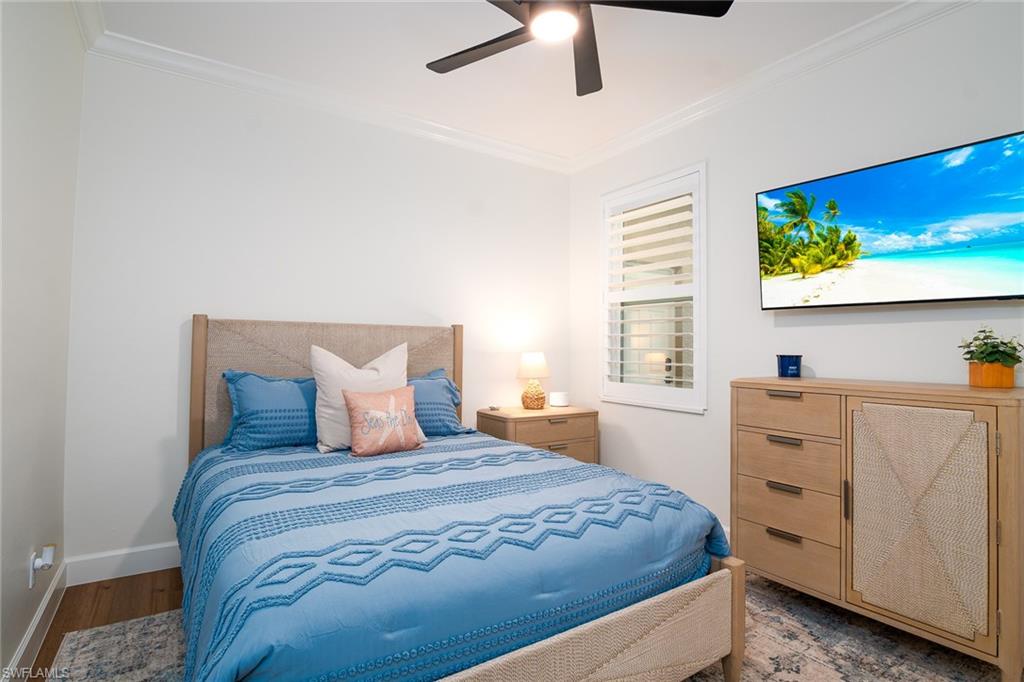 21441 Knighton Run Estero, FL 33928 - Photo 21 of 50 a bedroom with a bed and a flat tv screen on dresser