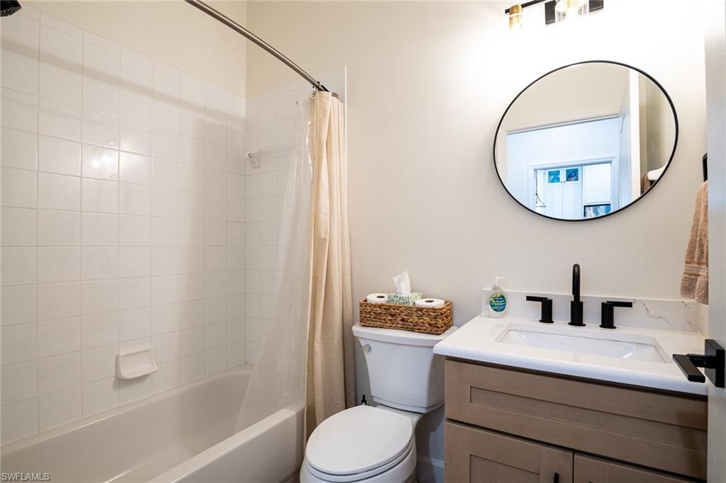 21441 Knighton Run Estero, FL 33928 - Photo 22 of 50 a bathroom with a sink a toilet and a mirror