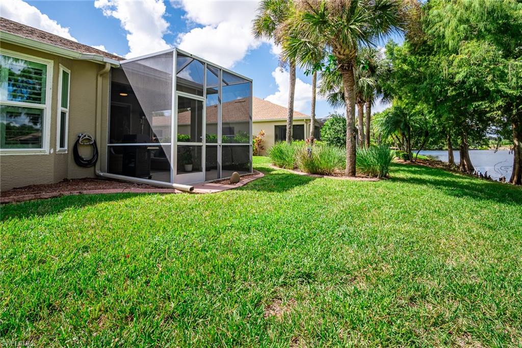 21441 Knighton Run Estero, FL 33928 - Photo 37 of 50 a view of an house with backyard space and garden