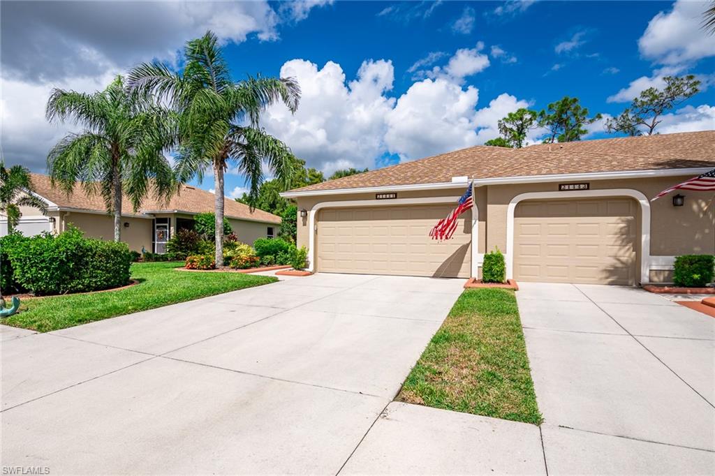 21441 Knighton Run Estero, FL 33928 - Photo 38 of 50 a front view of a house with a yard and a garage