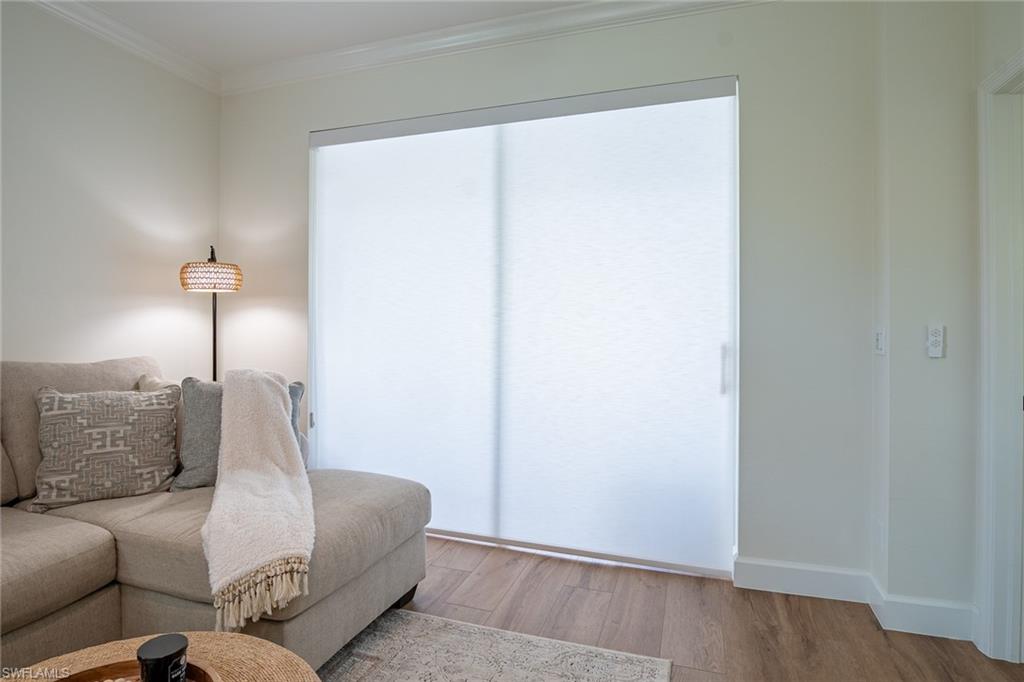 21441 Knighton Run Estero, FL 33928 - Photo 5 of 50 a living room with furniture and a wooden floor