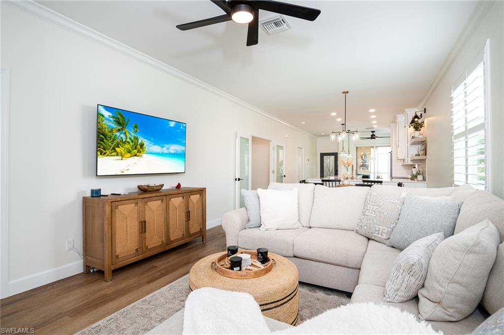 21441 Knighton Run Estero, FL 33928 - Photo 6 of 50 a living room with furniture and a painting on the wall