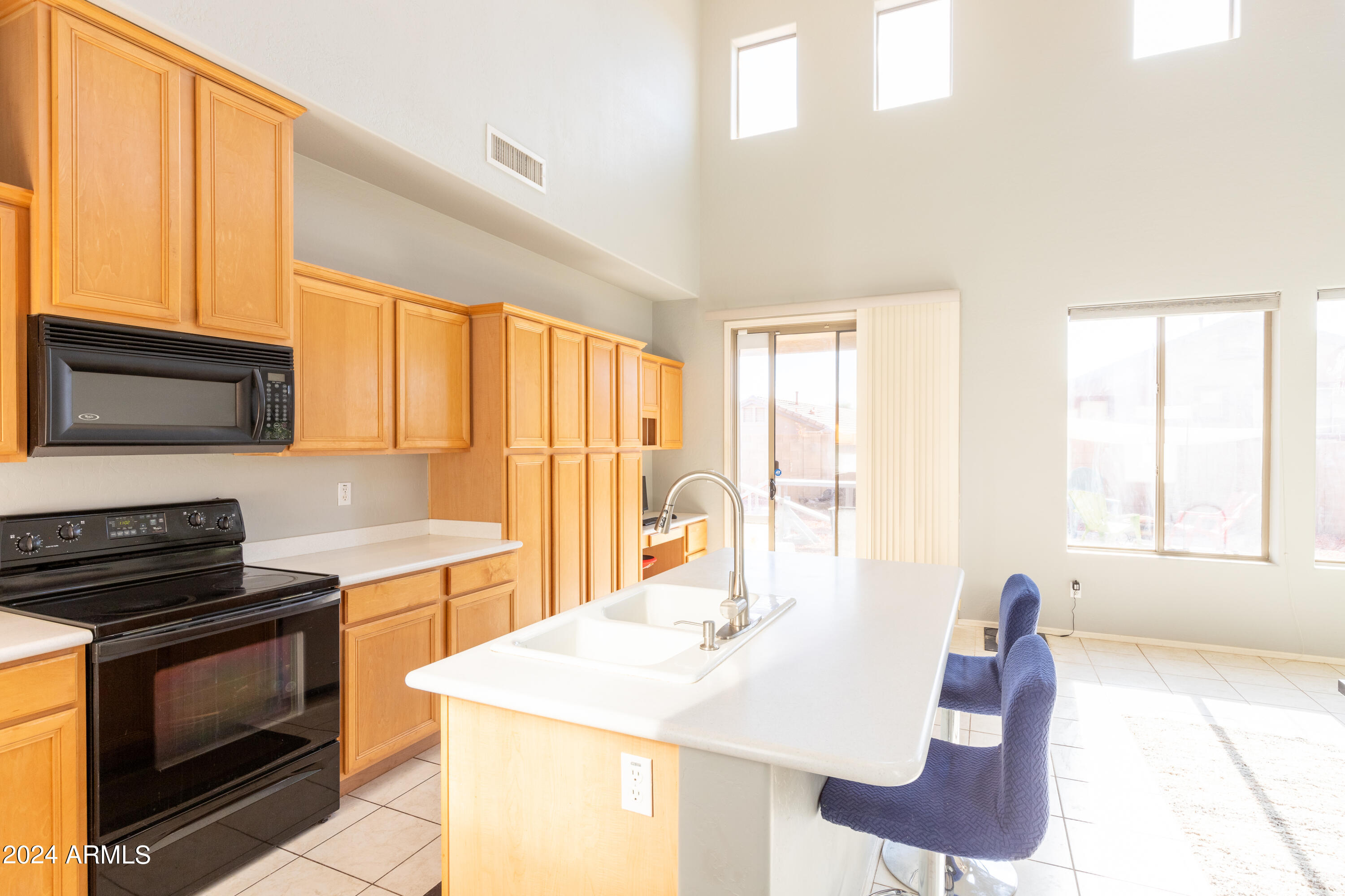 2929 West Silver Fox Way Phoenix, AZ 85045 - Photo 11 of 25 a kitchen with a stove a sink and a microwave