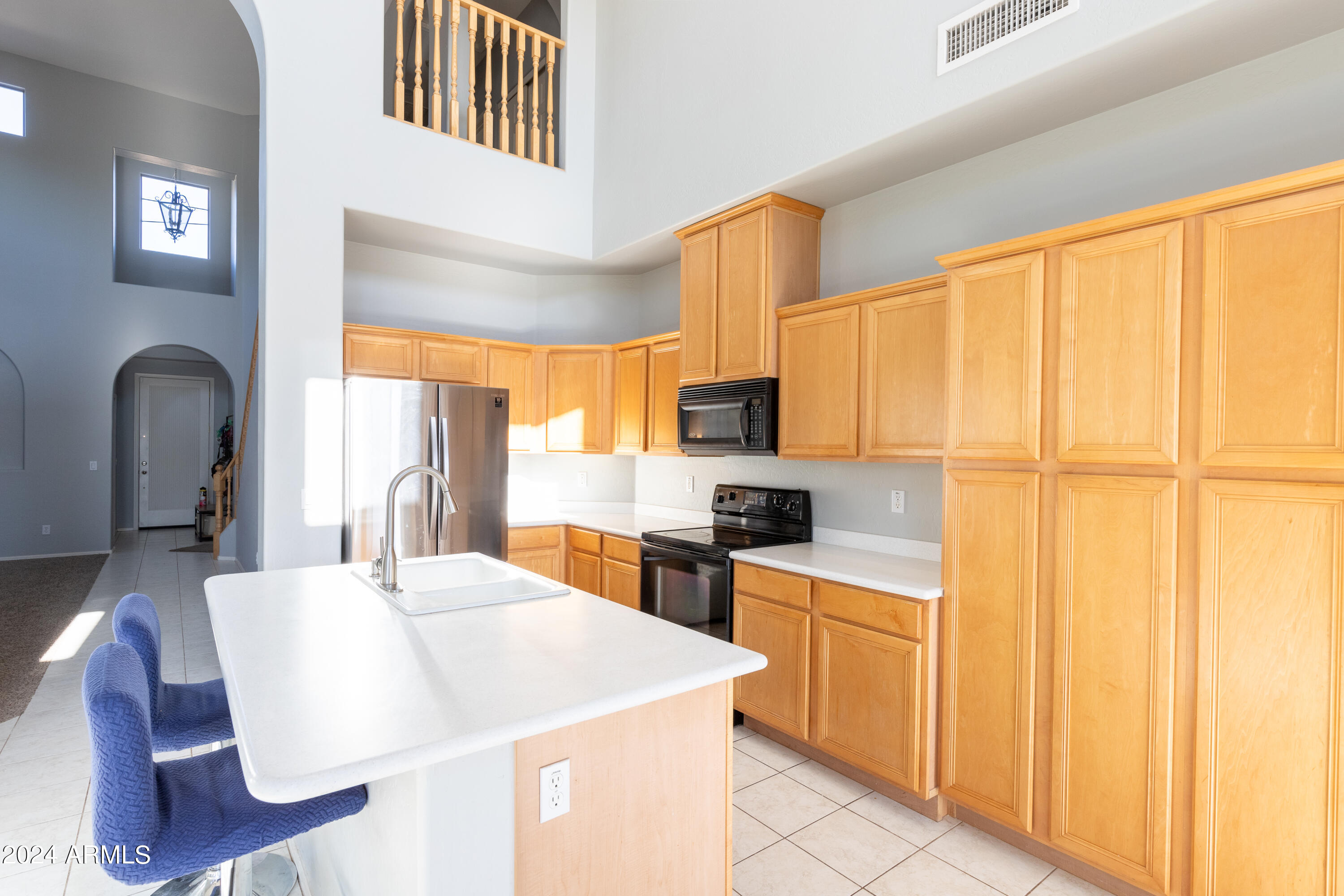 2929 West Silver Fox Way Phoenix, AZ 85045 - Photo 12 of 25 a kitchen with a stove a sink and a refrigerator