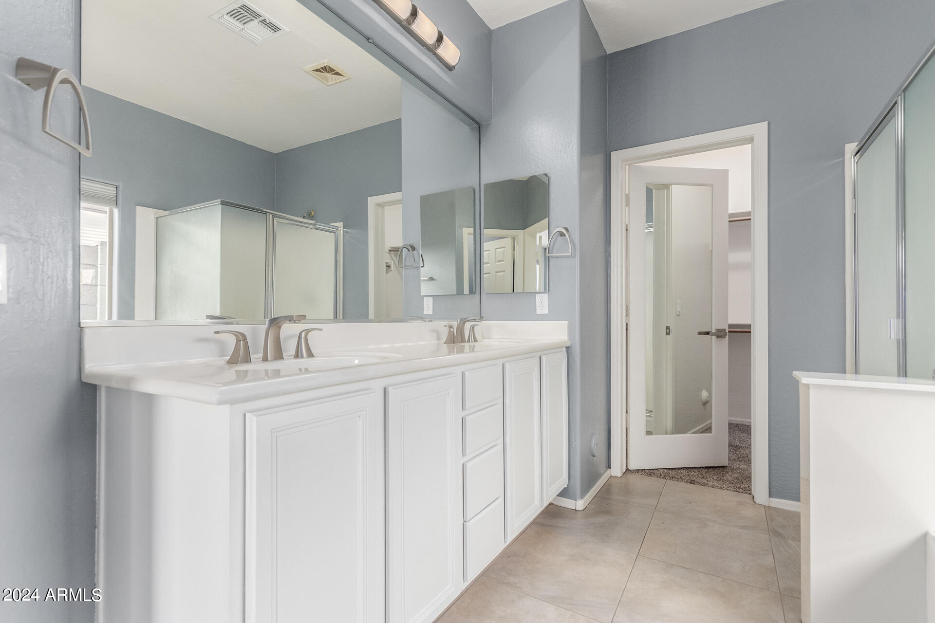 2929 West Silver Fox Way Phoenix, AZ 85045 - Photo 16 of 25 a bathroom with a sink and a mirror