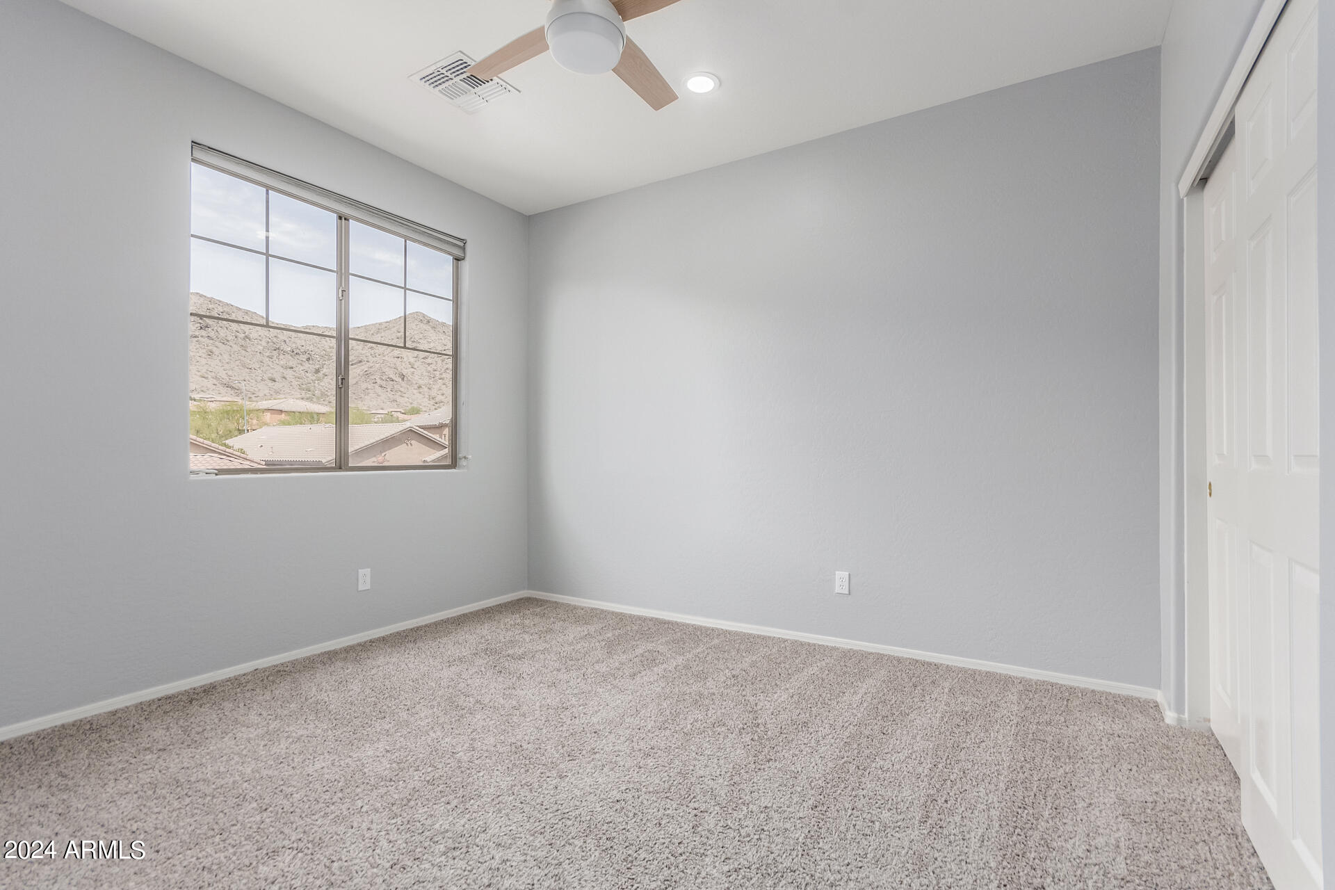 2929 West Silver Fox Way Phoenix, AZ 85045 - Photo 20 of 25 an empty room with a window and ceiling fan