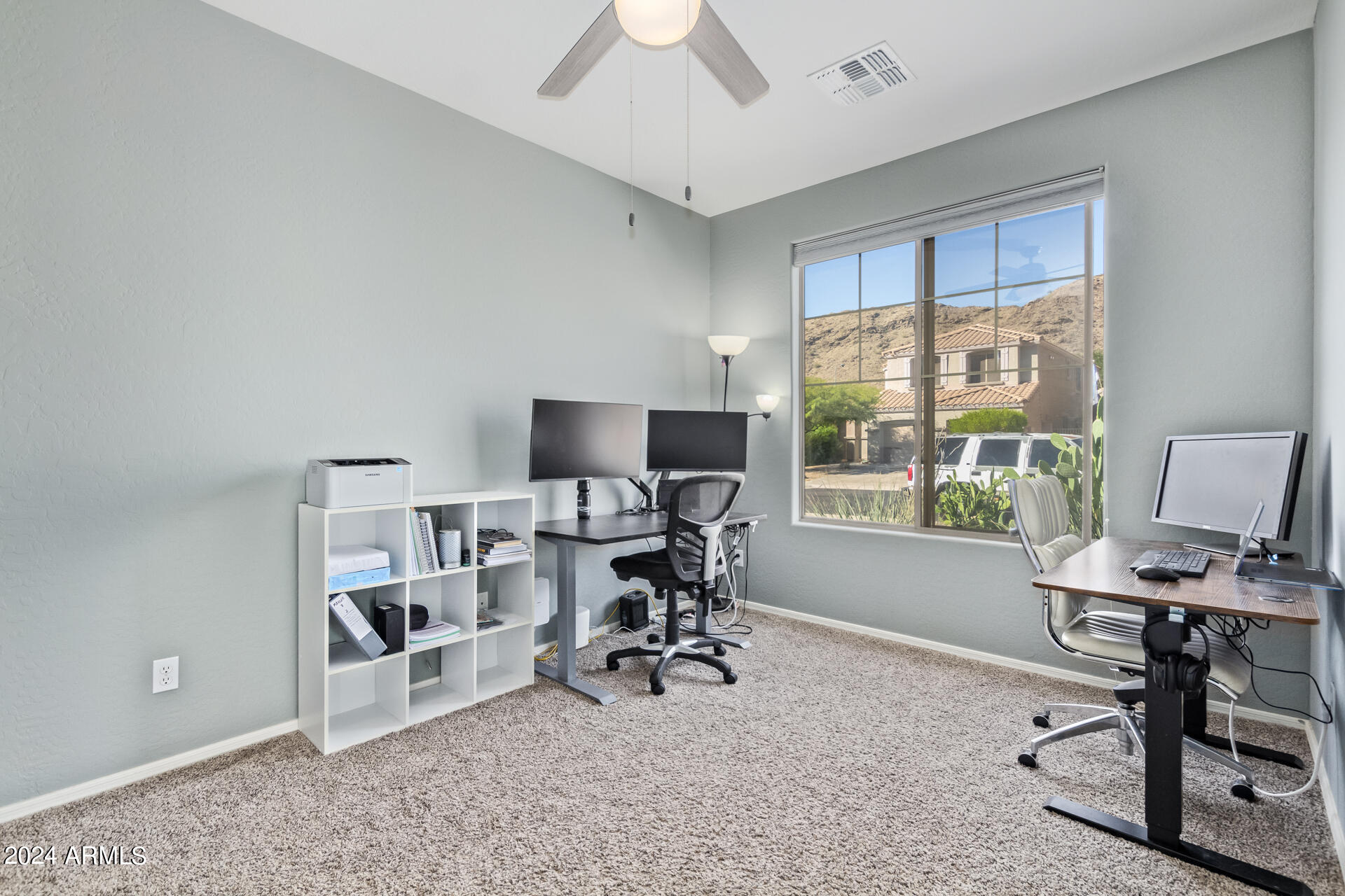 2929 West Silver Fox Way Phoenix, AZ 85045 - Photo 3 of 25 a view of a workspace with furniture and a window