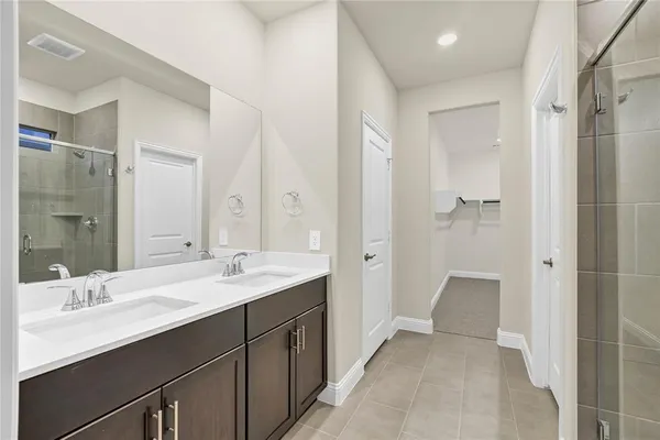 a bathroom with a double vanity sink mirror double and shower