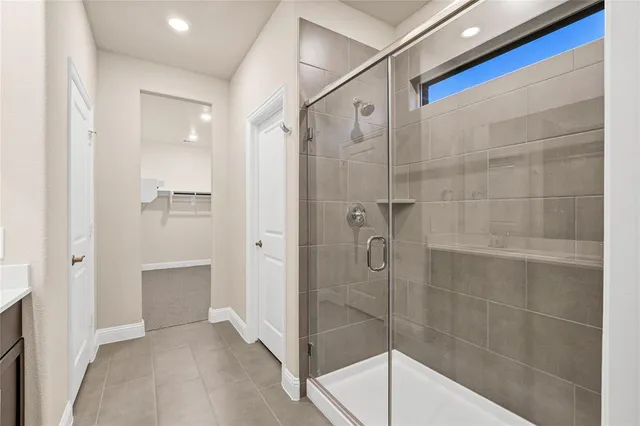a bathroom with a shower and a sink