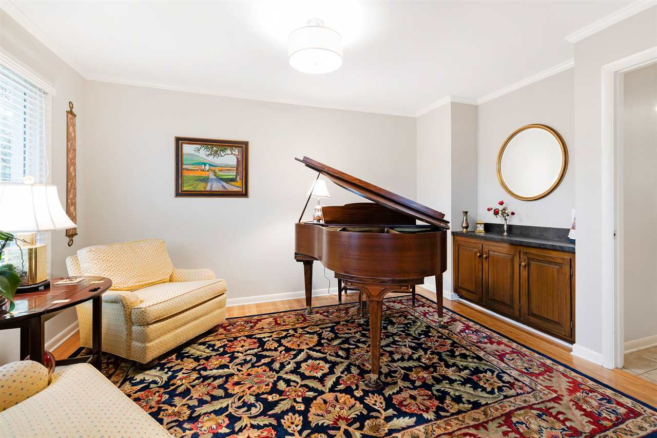 3325 Horton Street Raleigh, NC 27607 - Photo 12 of 30 The former dining room right off the kitchen now serves as the piano room and sitting area.