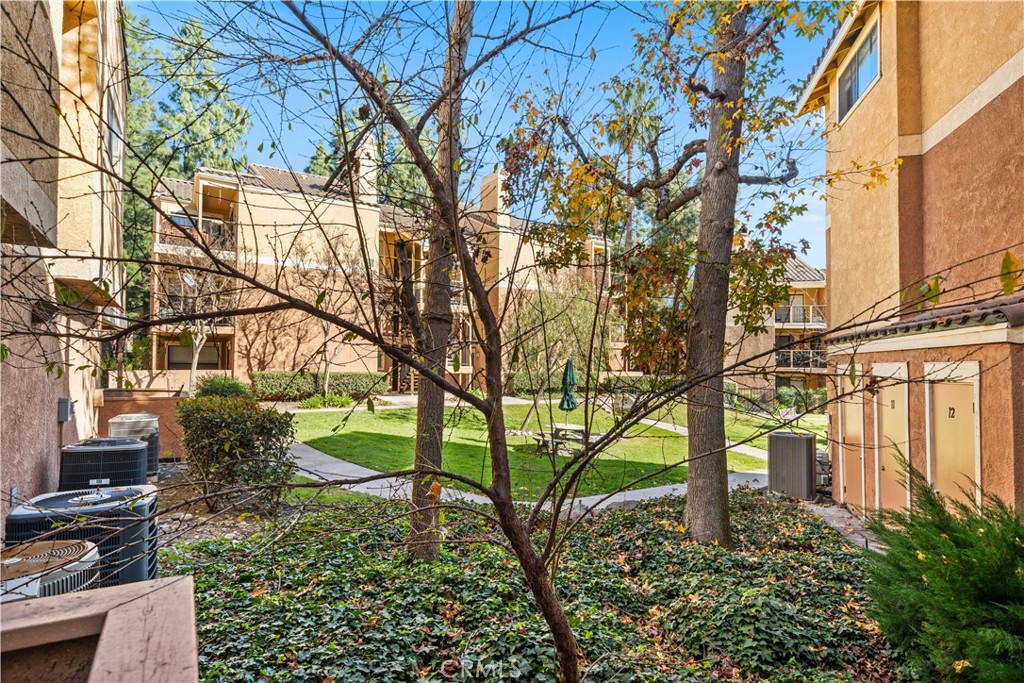 10655 Lemon Avenue, Unit 3107 Rancho Cucamonga, CA 91737 - Photo 12 of 55 a backyard of a house with lots of green space