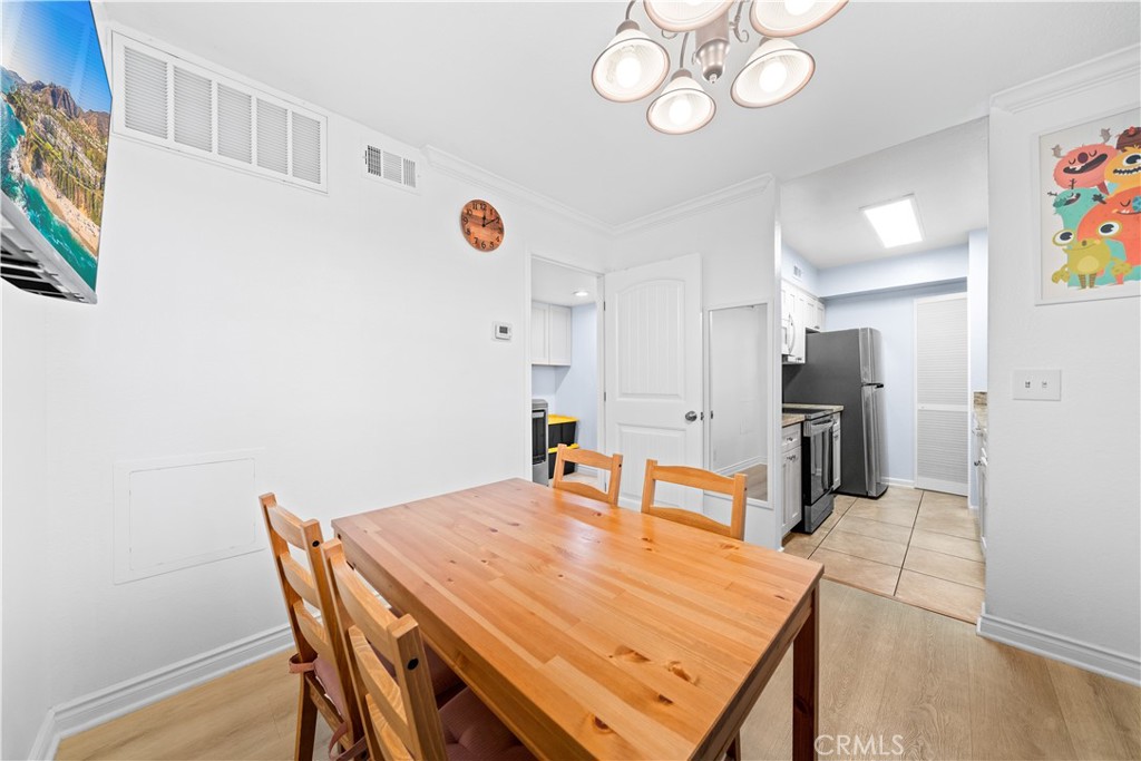 10655 Lemon Avenue, Unit 3107 Rancho Cucamonga, CA 91737 - Photo 16 of 55 a dining room with stainless steel appliances kitchen island granite countertop a table chairs and a refrigerator