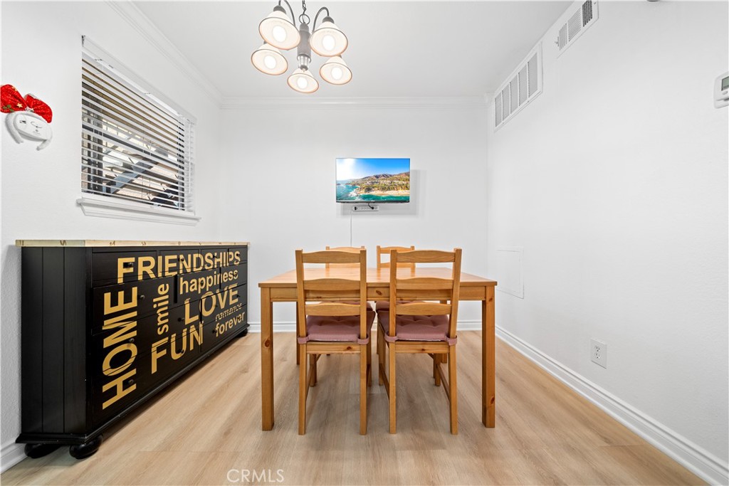 10655 Lemon Avenue, Unit 3107 Rancho Cucamonga, CA 91737 - Photo 20 of 55 a dining room with furniture wooden floor and a rug