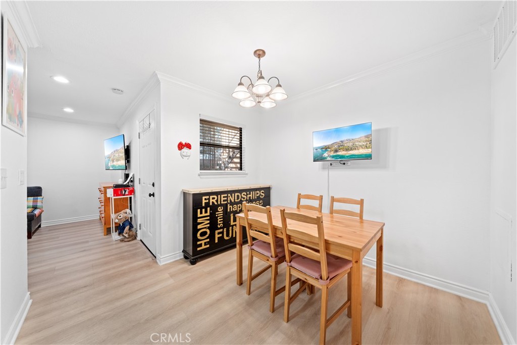 10655 Lemon Avenue, Unit 3107 Rancho Cucamonga, CA 91737 - Photo 21 of 55 a view of a dining room with furniture and wooden floor