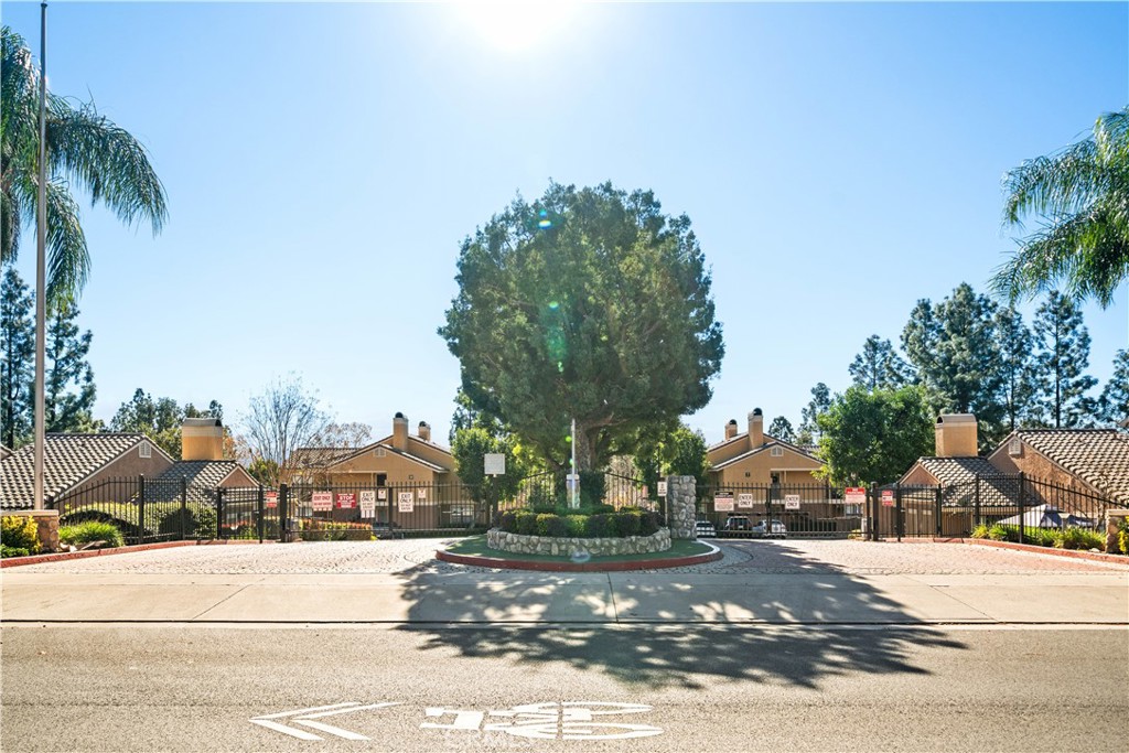 10655 Lemon Avenue, Unit 3107 Rancho Cucamonga, CA 91737 - Photo 31 of 55 a front view of a house with a yard and palm trees