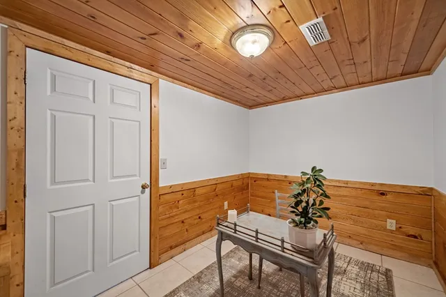 a view of a patio with table and chairs and potted plants